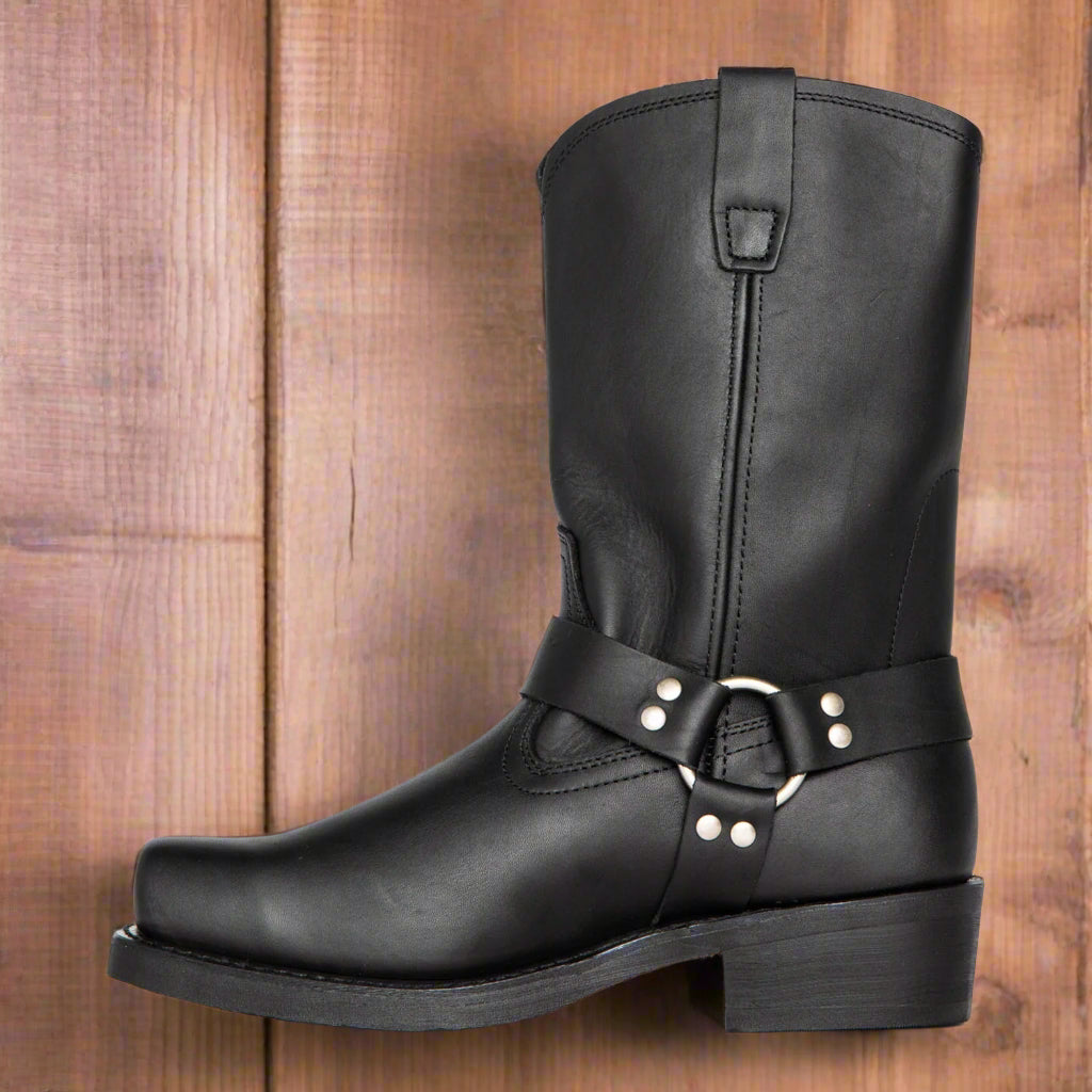 Black leather boot with a strap and buckle on a white background