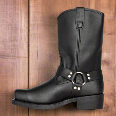 Black leather boot with a strap and buckle on a white background